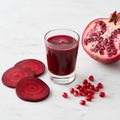 Beet and pomegranate wellness shot in a clear shot glass