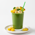 A vibrant tropical green smoothie with kale, spinach, mango, banana, pineapple, and coconut water in a clear glass with fresh fruit garnishes